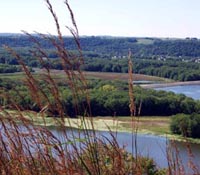 a view of the Mississippi River through the grass of a prairie cliff